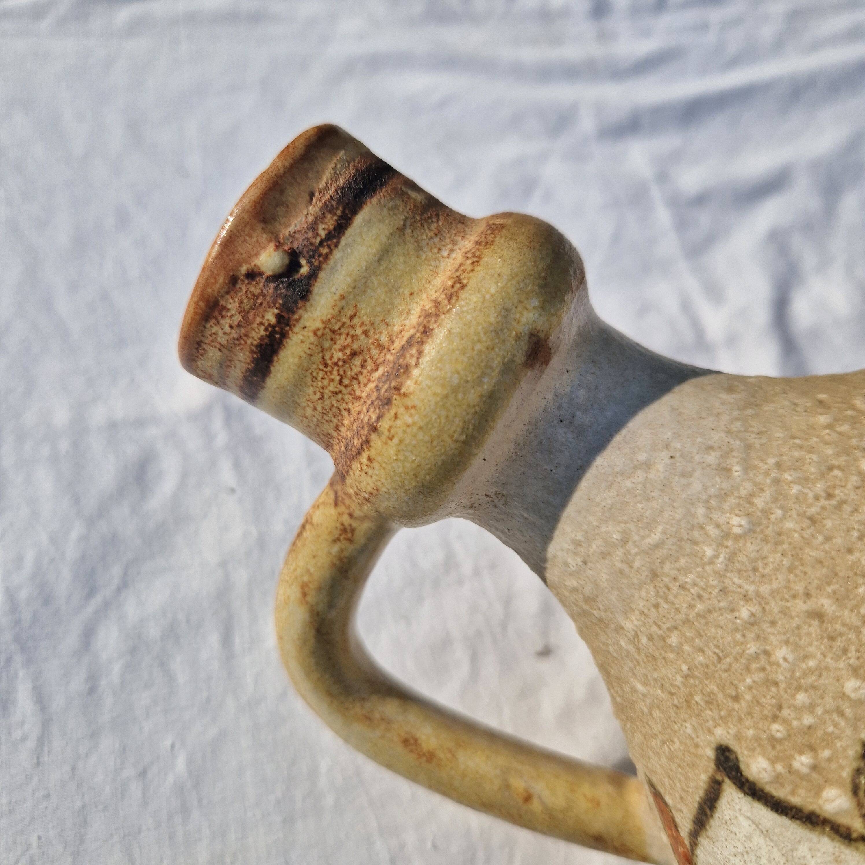 Handcrafted jug or jar with a handle, terracotta pottery vase, fat lava effect, stylized flowers