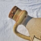 Handcrafted jug or jar with a handle, terracotta pottery vase, fat lava effect, stylized flowers