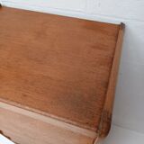 High wooden chest of drawers in the 50s