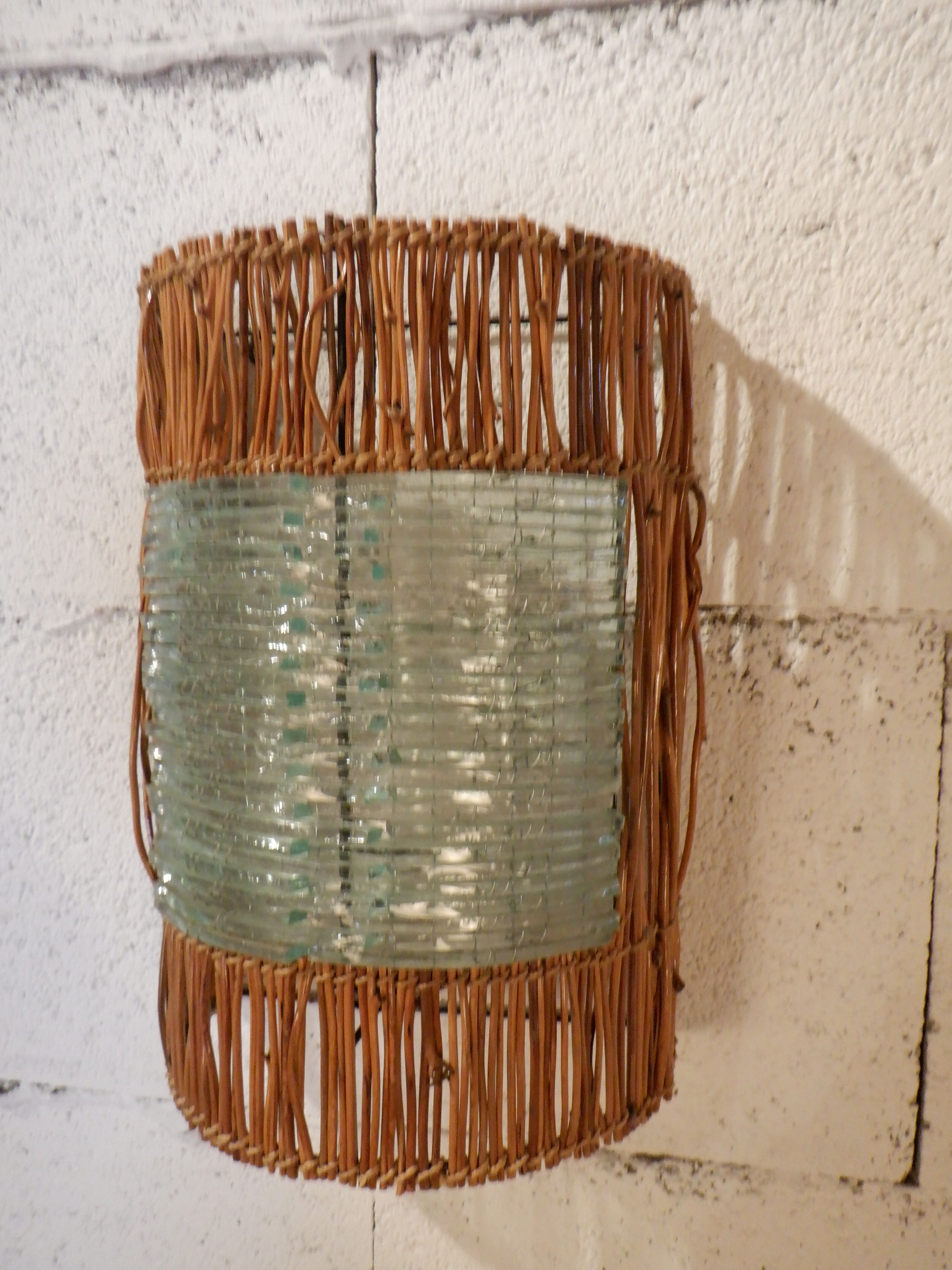 Glass and rattan sconce