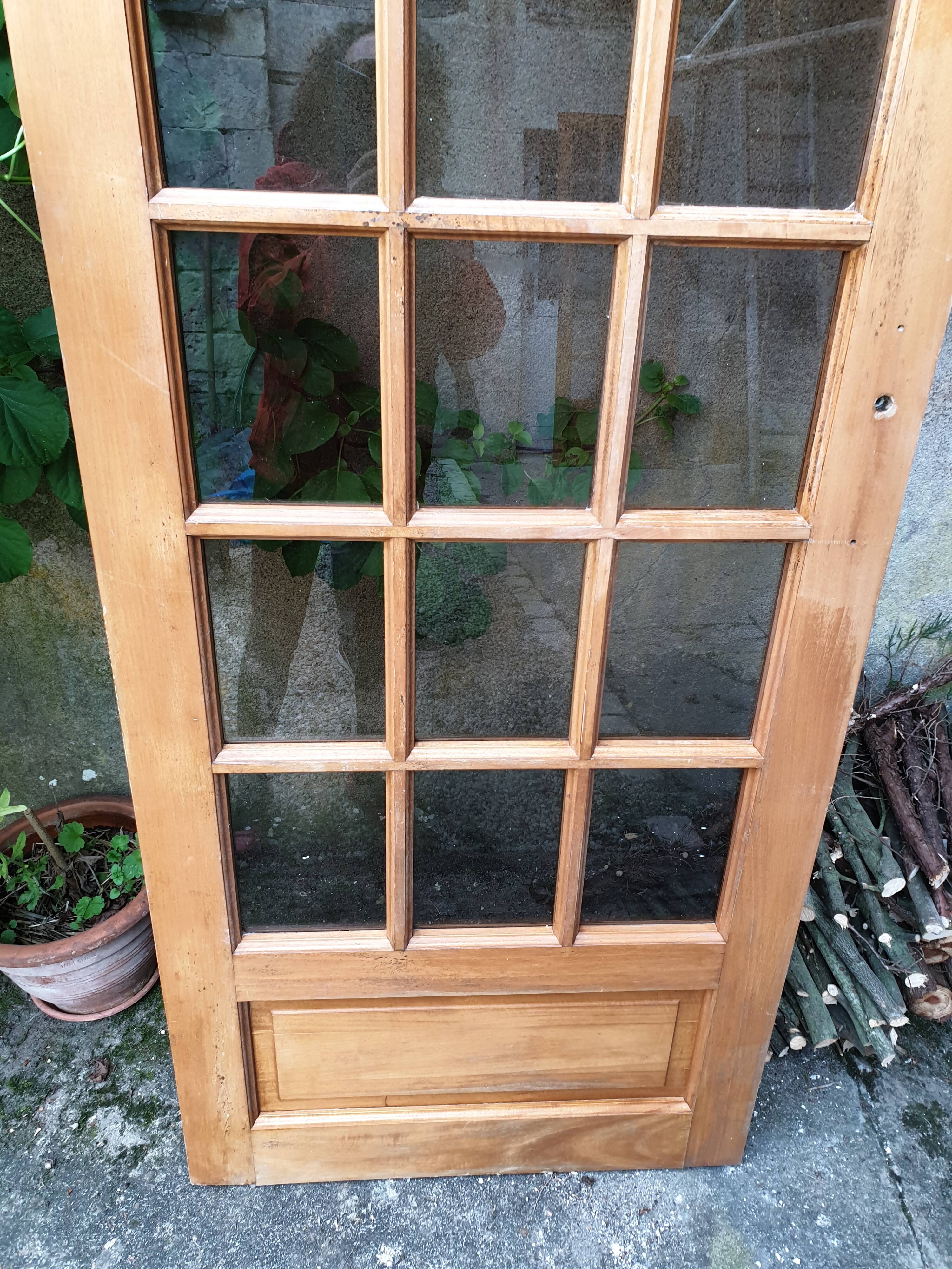 Old wooden door glazed with small tiles