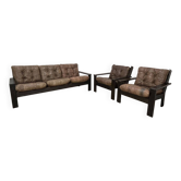 Living room with leather and wood sofas and armchairs, 1970s, brutalist chalet style.