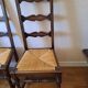 6 wooden and straw chairs