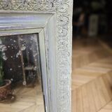 Old mirror with light green contours with mauve shades