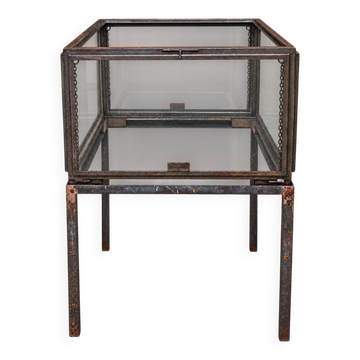 A showcase made of steel and glass, mounted on a custom-made steel base.