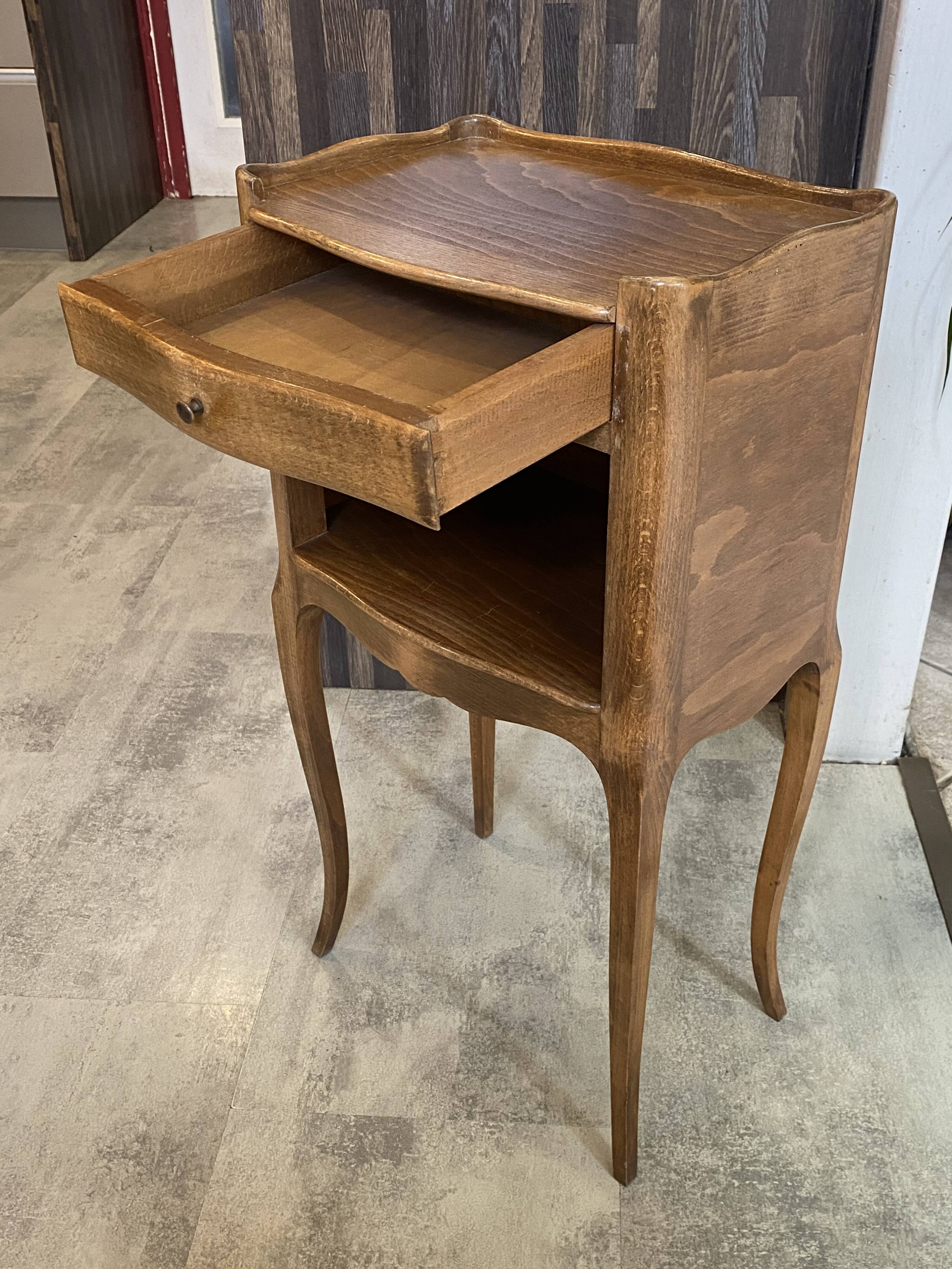 A bedside table with a drawer and a niche in Louis XV style.