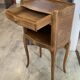 A bedside table with a drawer and a niche in Louis XV style.