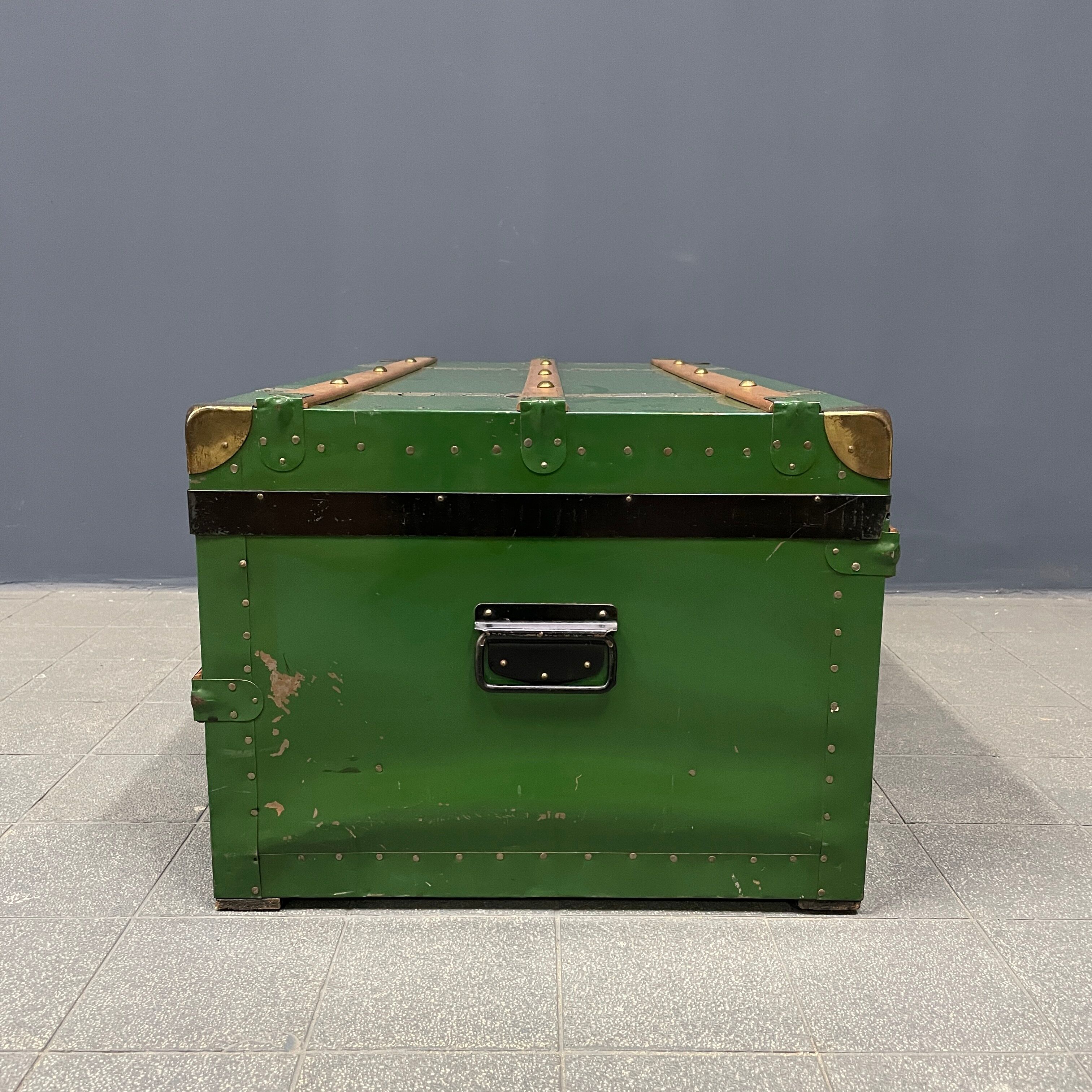 Green metal trunk with wooden sleds
