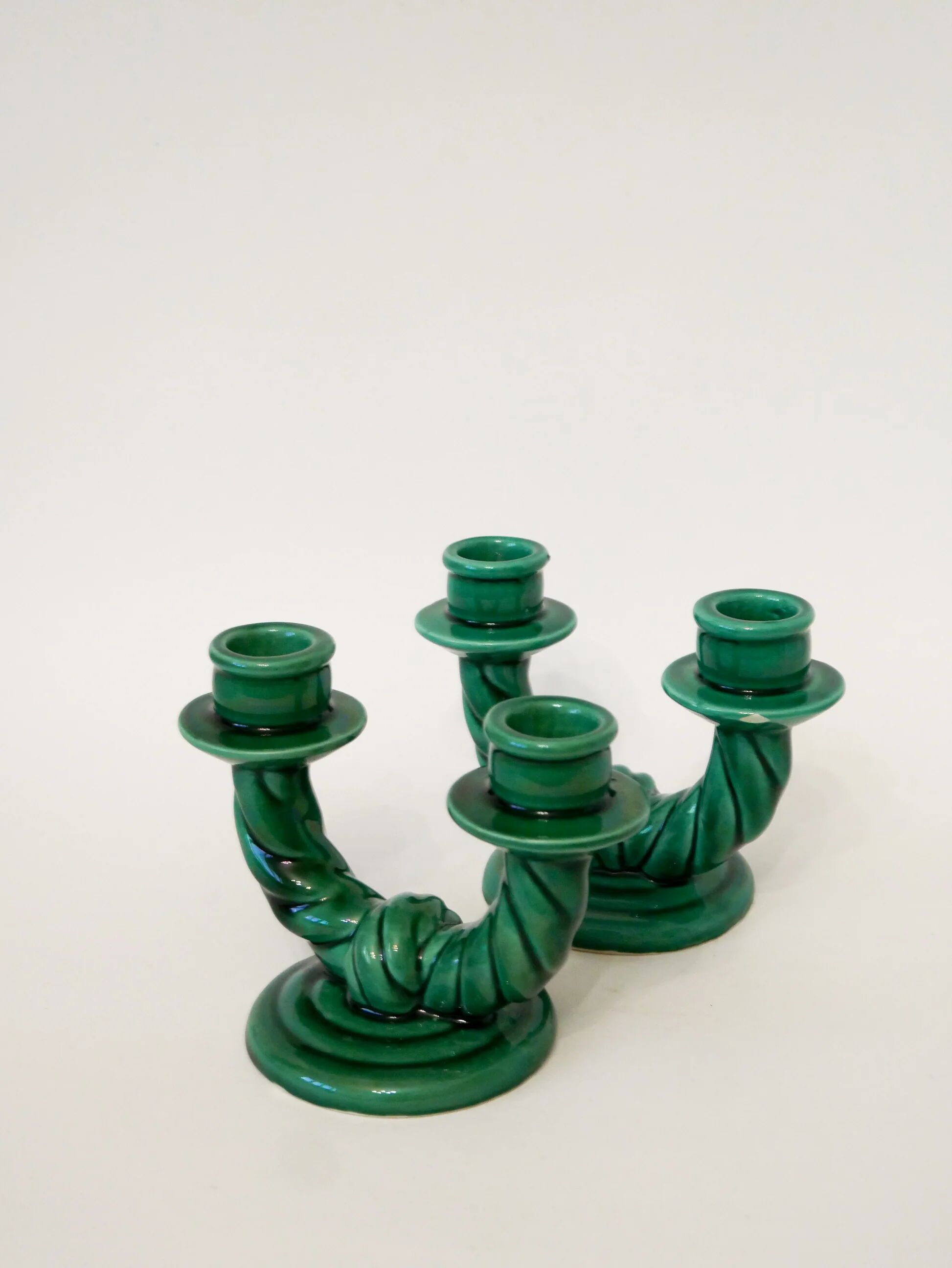 Pair of twisted green ceramic double candlesticks, 1960.