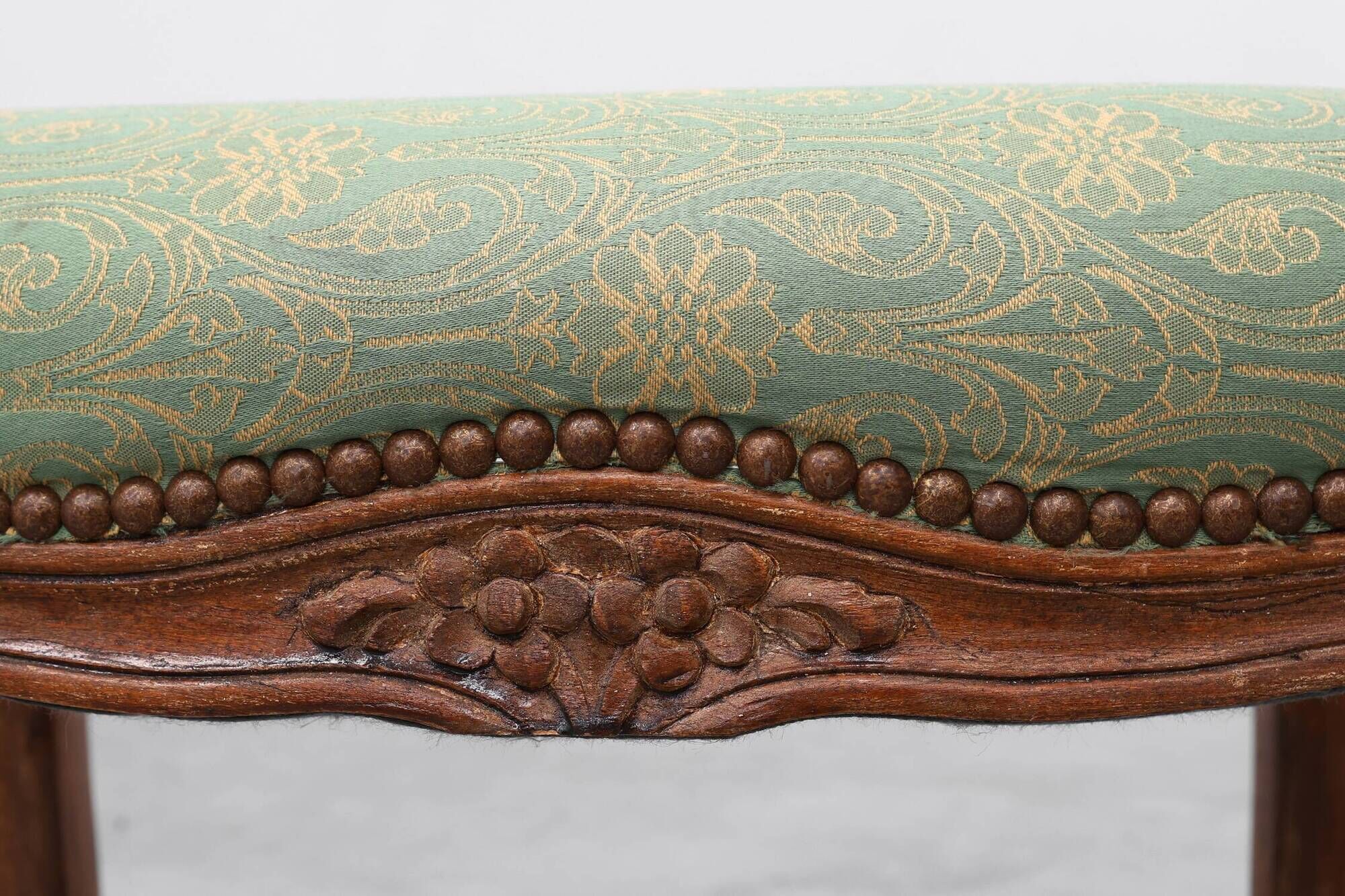 Louis XV stool with carved floral apron and original damask upholstery