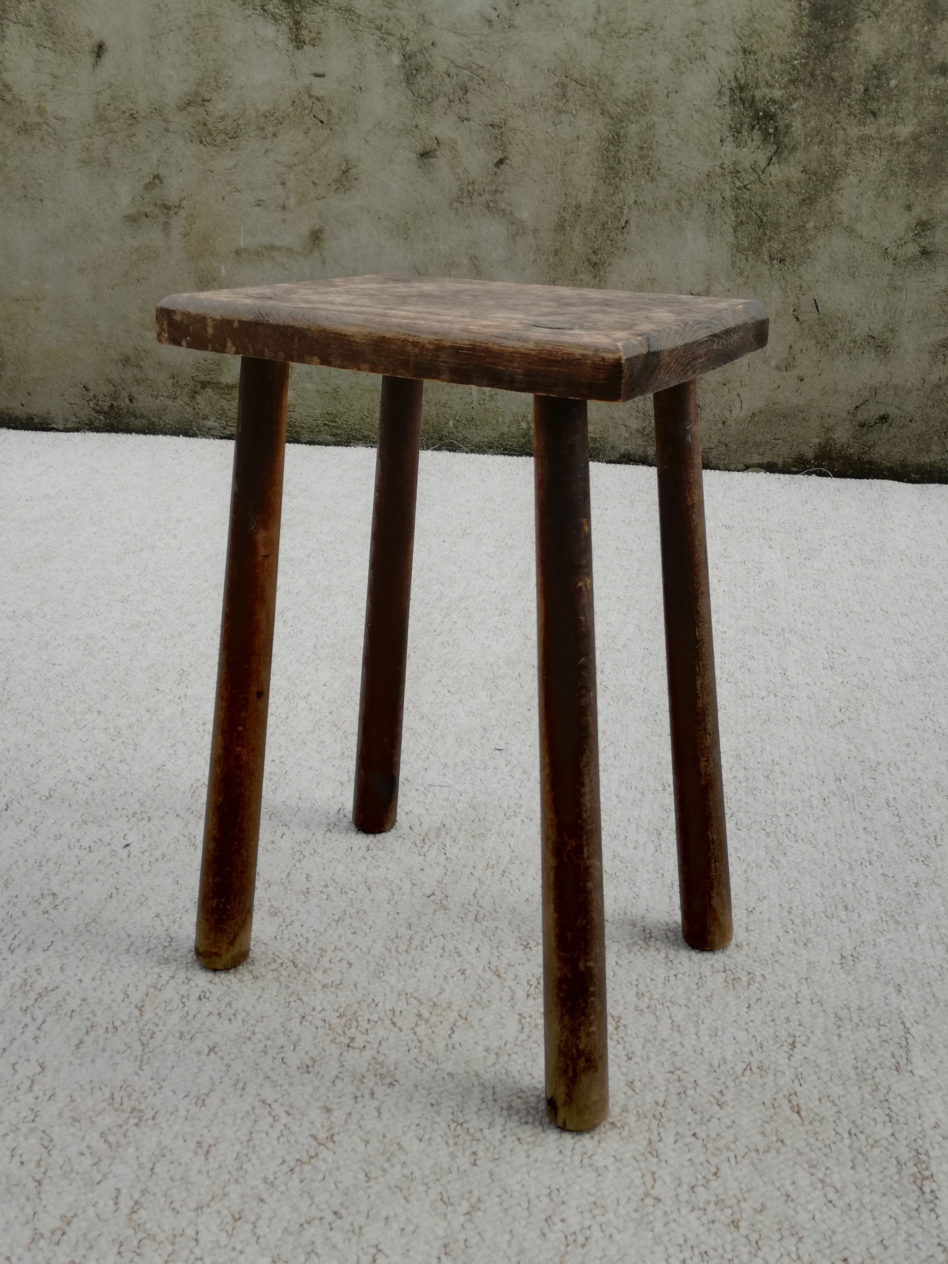Old wooden stool with log feet