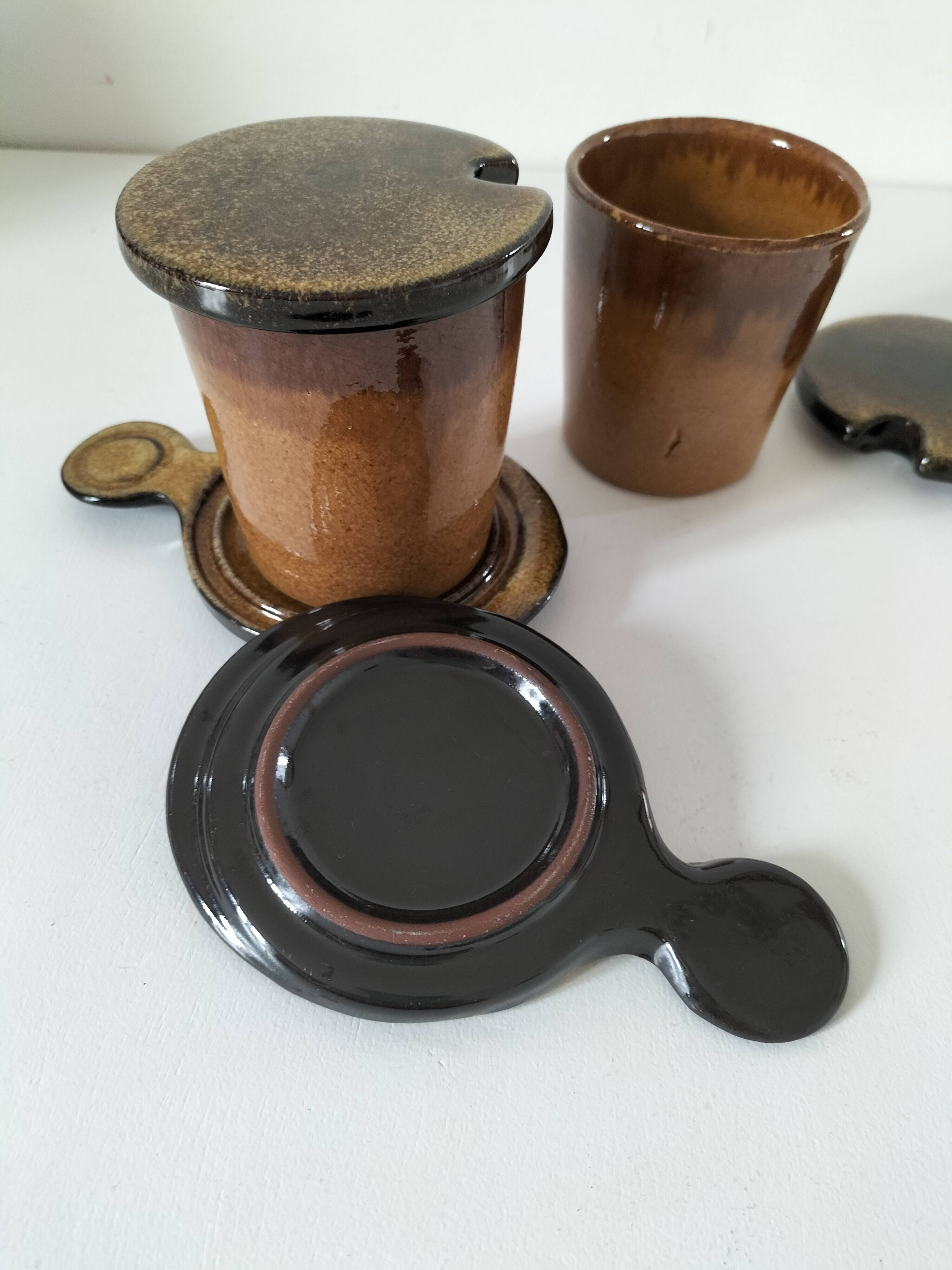 Pair of glazed stoneware cups with saucers and lids