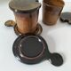 Pair of glazed stoneware cups with saucers and lids