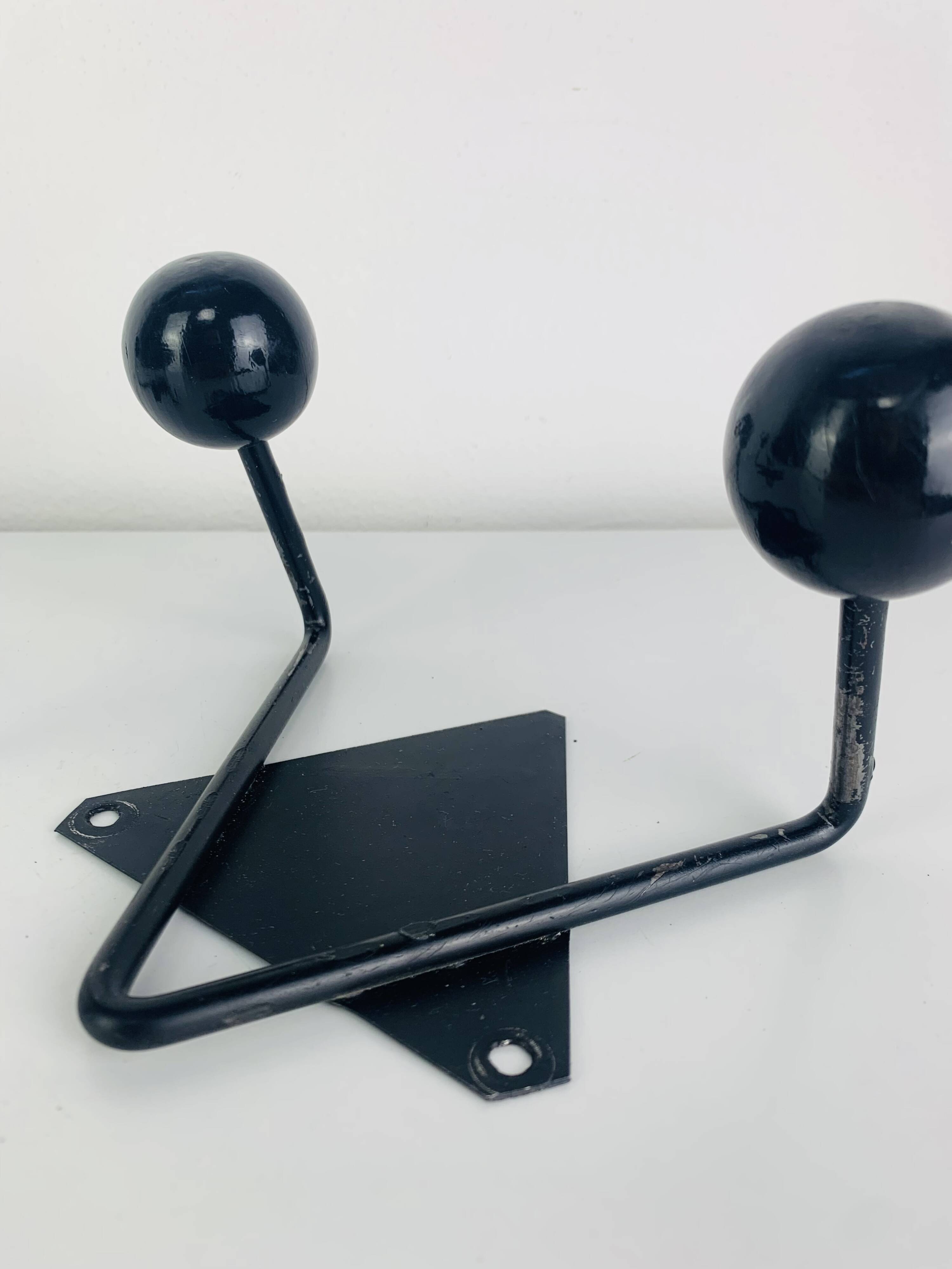 Pair of wall hooks from the 1950s, black metal