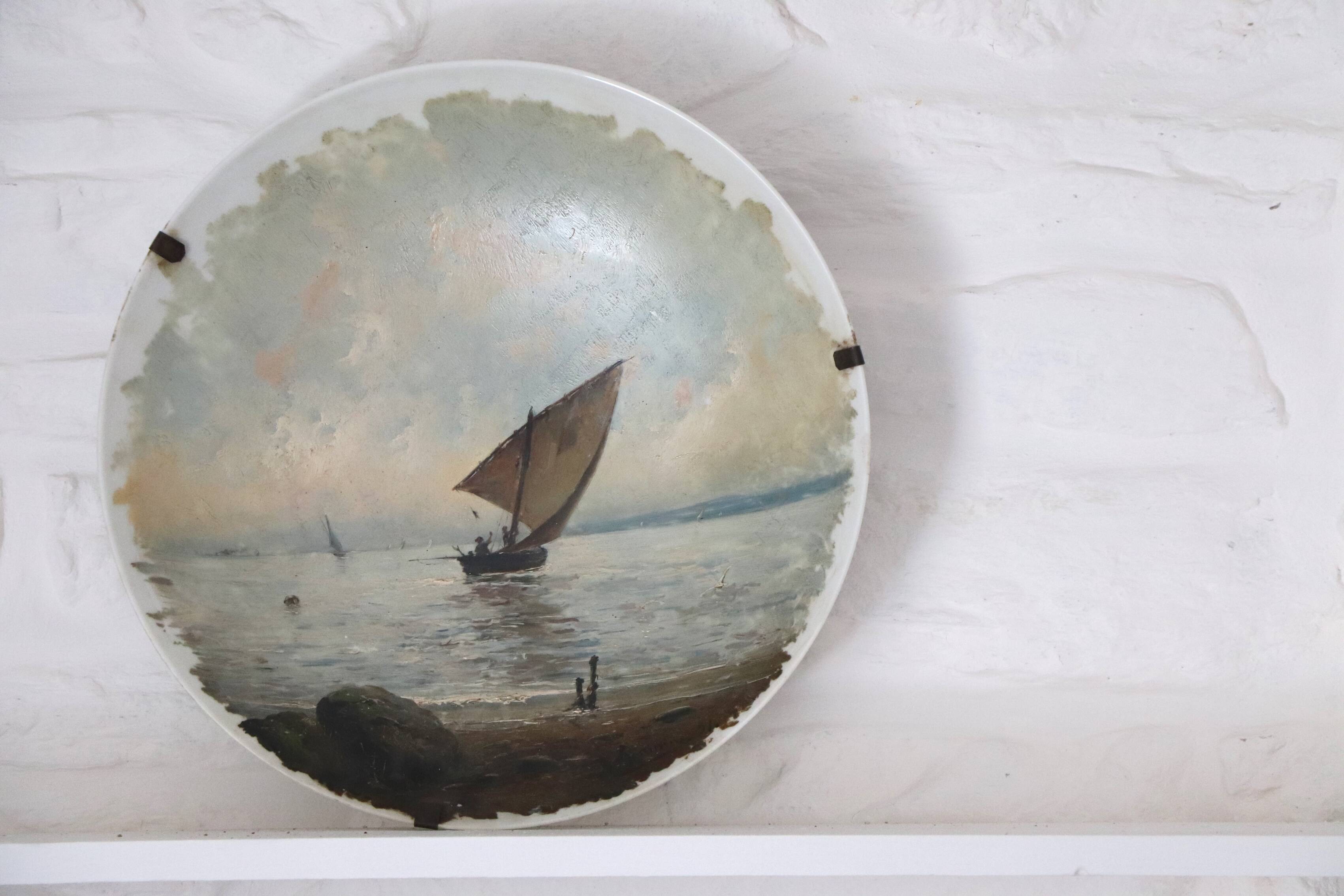 Pair of large hand-painted plates, sailing boat and landscape – late 19th century