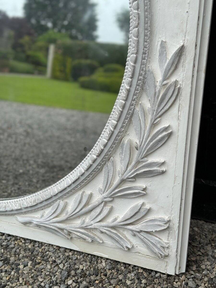 Louis XVI style fireplace mirror, carved wood trumeau with white and grey highlights, 18th century