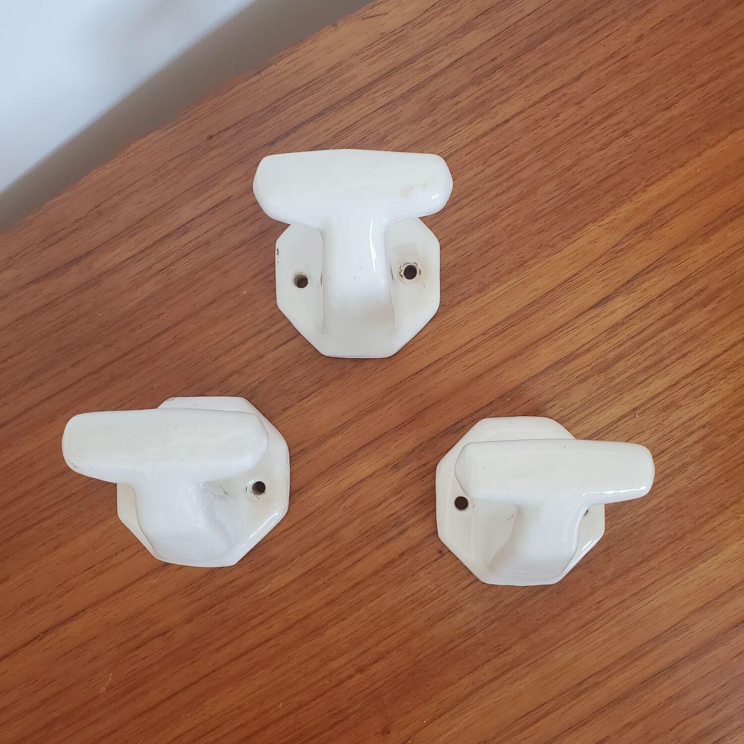 Trio of white porcelain hooks