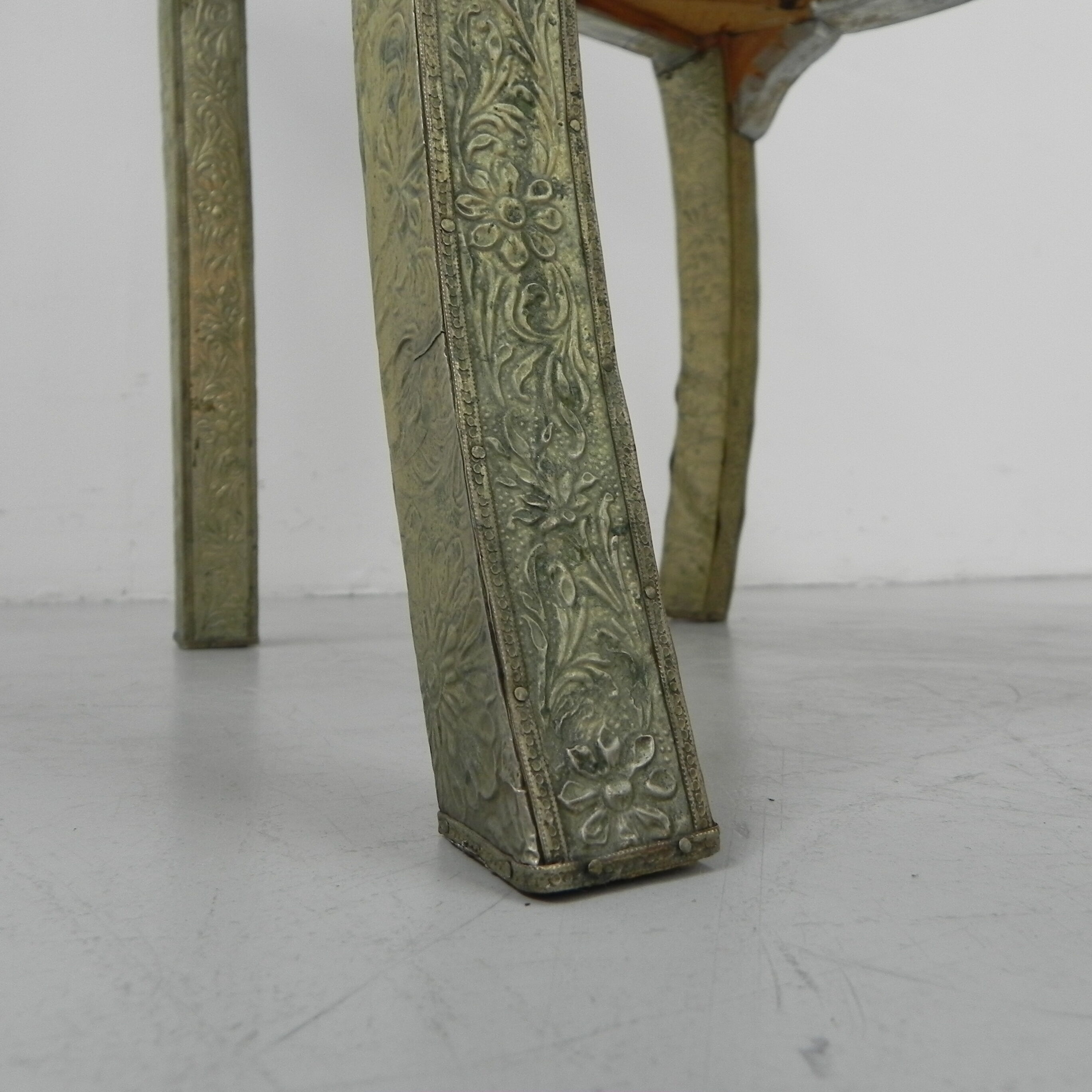 Dining chair upholstered with stamped tin