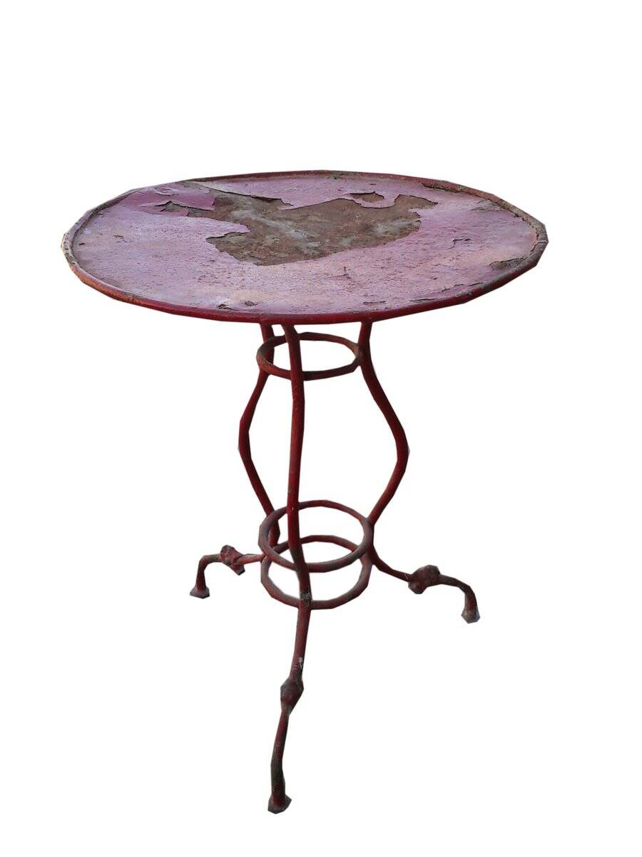 Vintage red cast iron bistro table (1950s) — round metal top, tripod base.