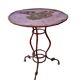 Vintage red cast iron bistro table (1950s) — round metal top, tripod base.