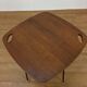 Modernist side table, 1950s, wood and metal, with handles.