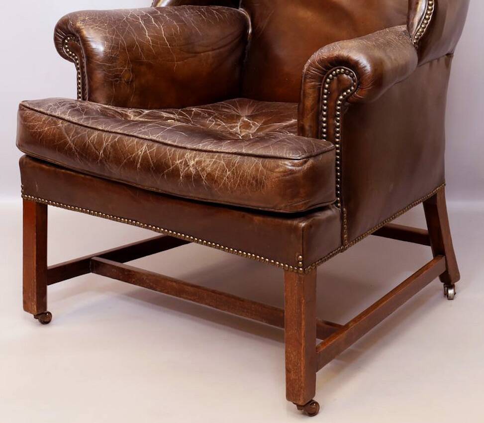 Wingback armchair in dark brown patinated leather, 1970s