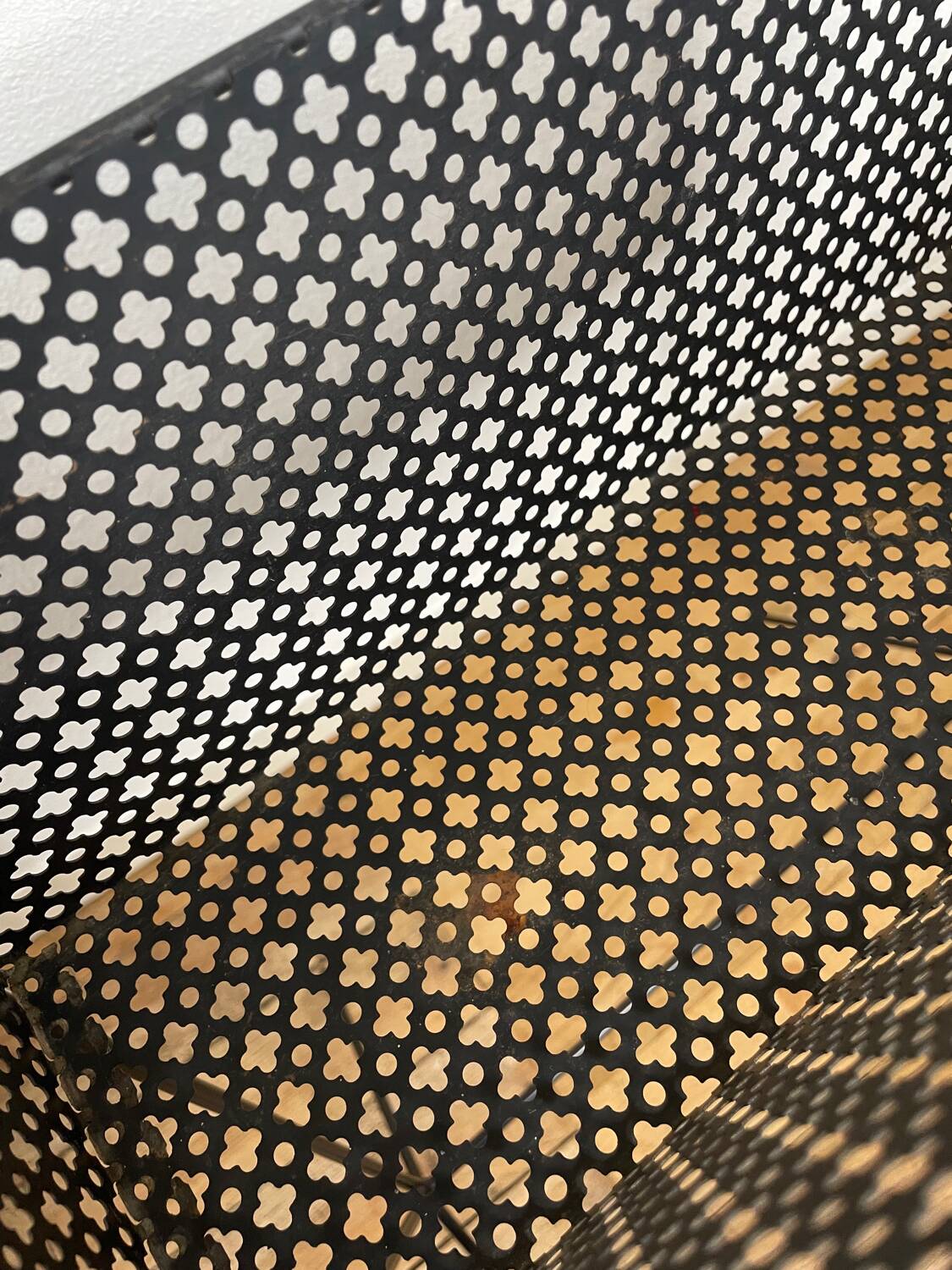 1950s black perforated metal planter in the style of Mathieu MATEGOT