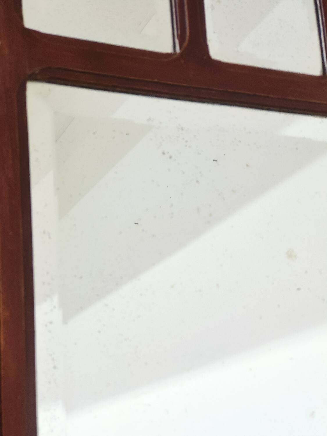 Antique beveled mirror on a wooden frame, 1930