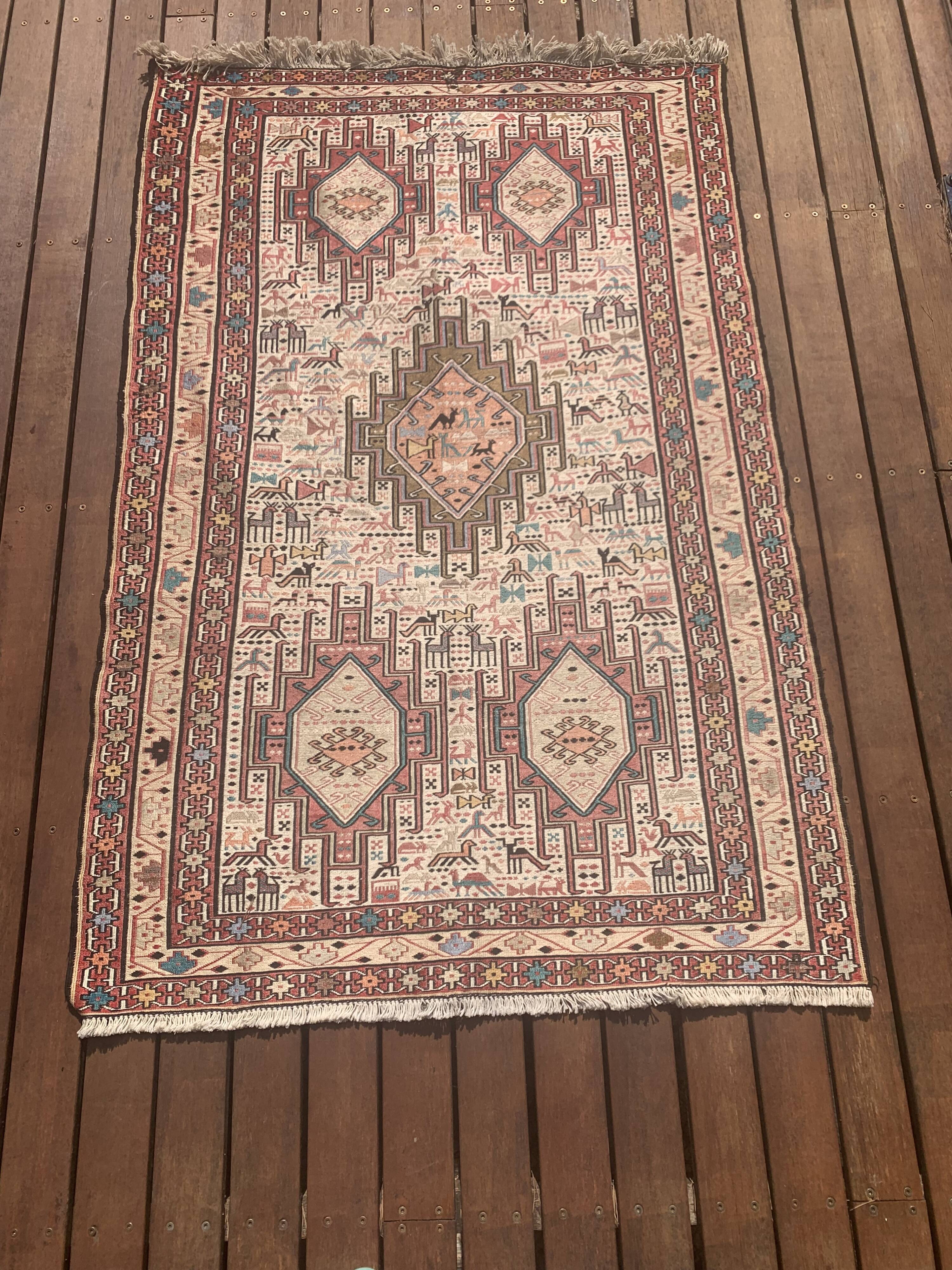 Hand-knotted silk carpet purchased in Iran – geometric and animal design –