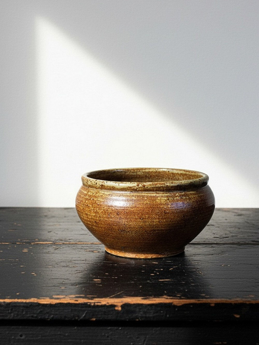 Vintage glazed stoneware bowl or planter in rustic wabi-sabi style.