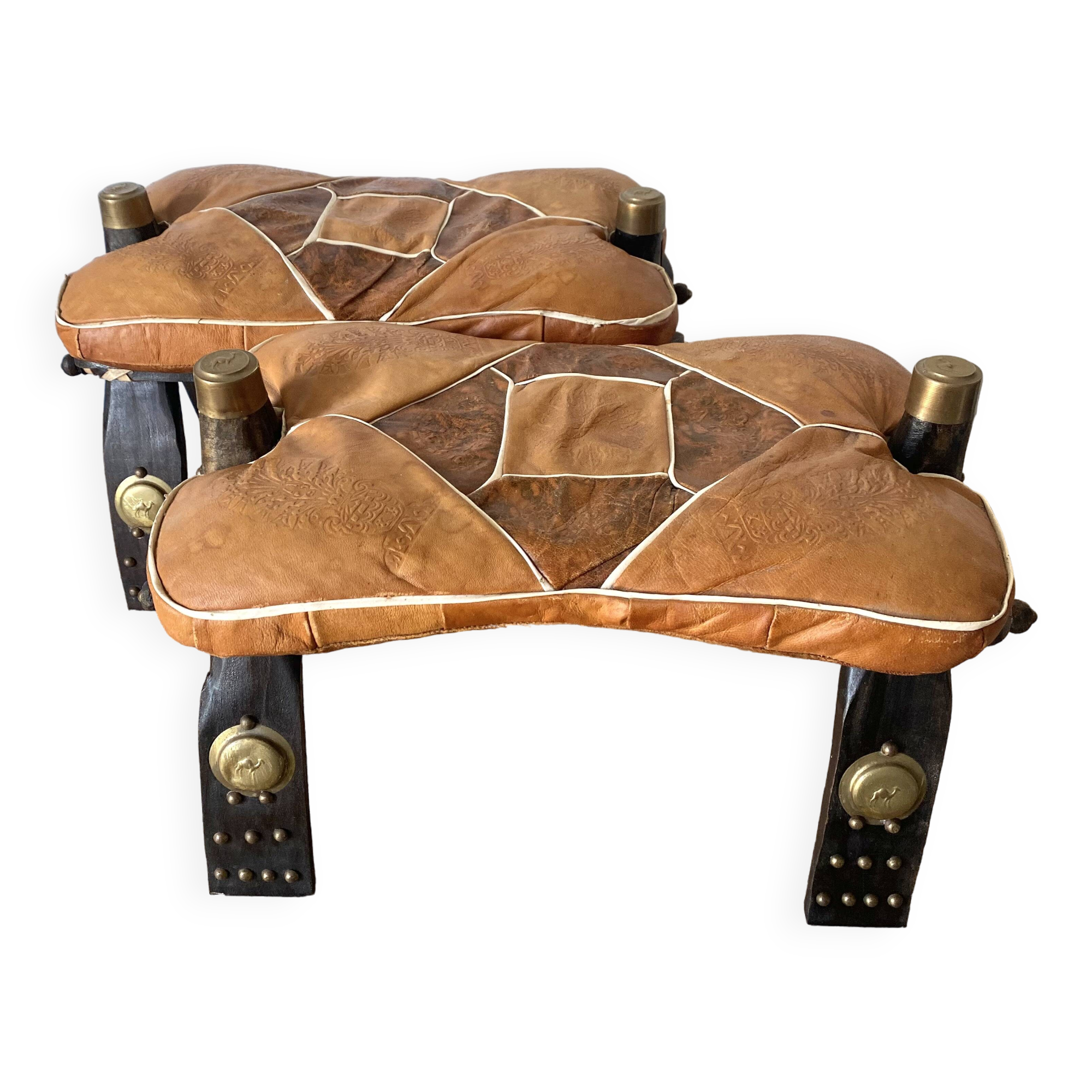 Pair of low Egyptian stools, camel saddles in wood, leather and brass