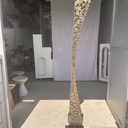 Indonesian construction element in carved wood with intertwined plant motifs mounted on a base (fri