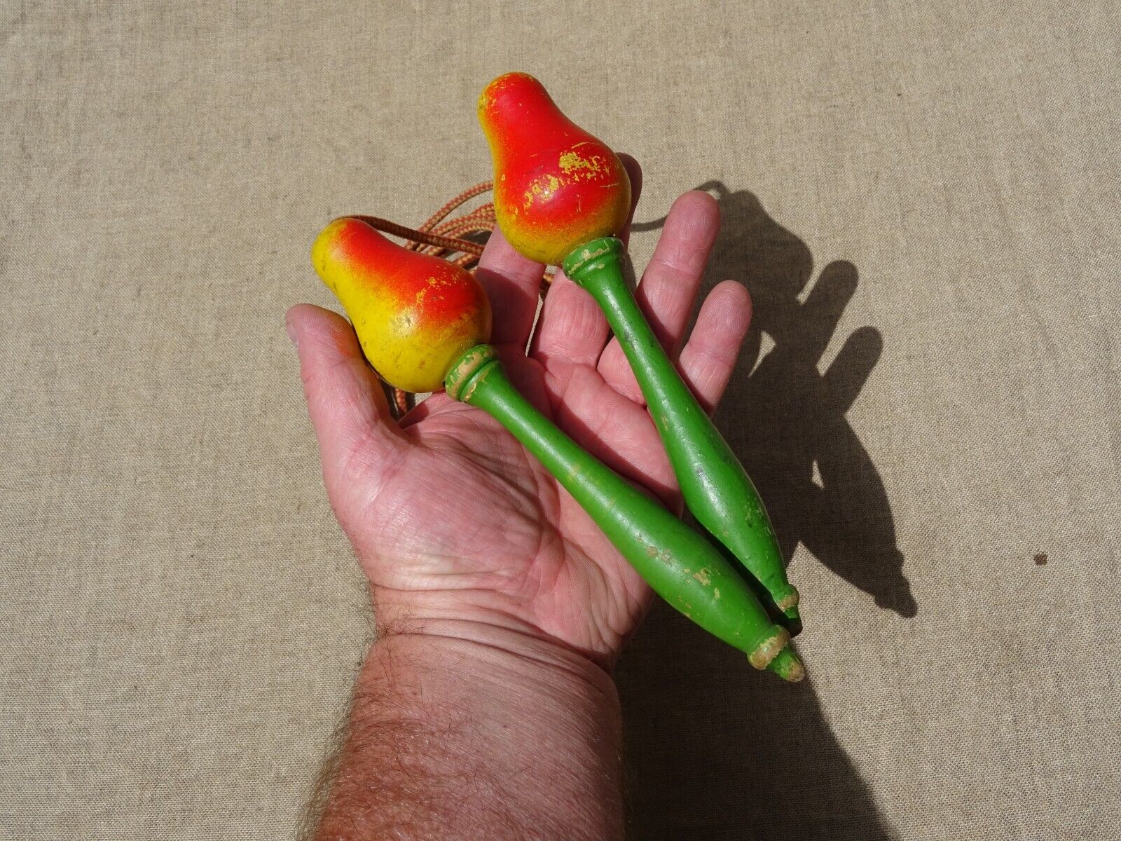 Old wooden jump rope toy painted in the shape of pear fruit ref