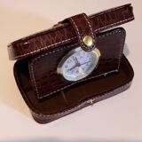 Small travel alarm clock in its case with jewelry compartments