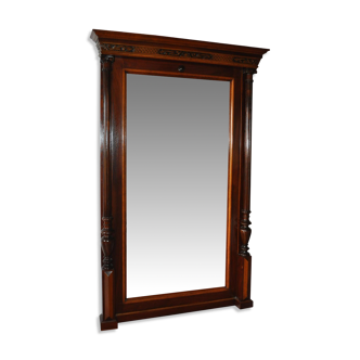Large carved brown mahogany wall mirror in classic 19th-century style, original glass.