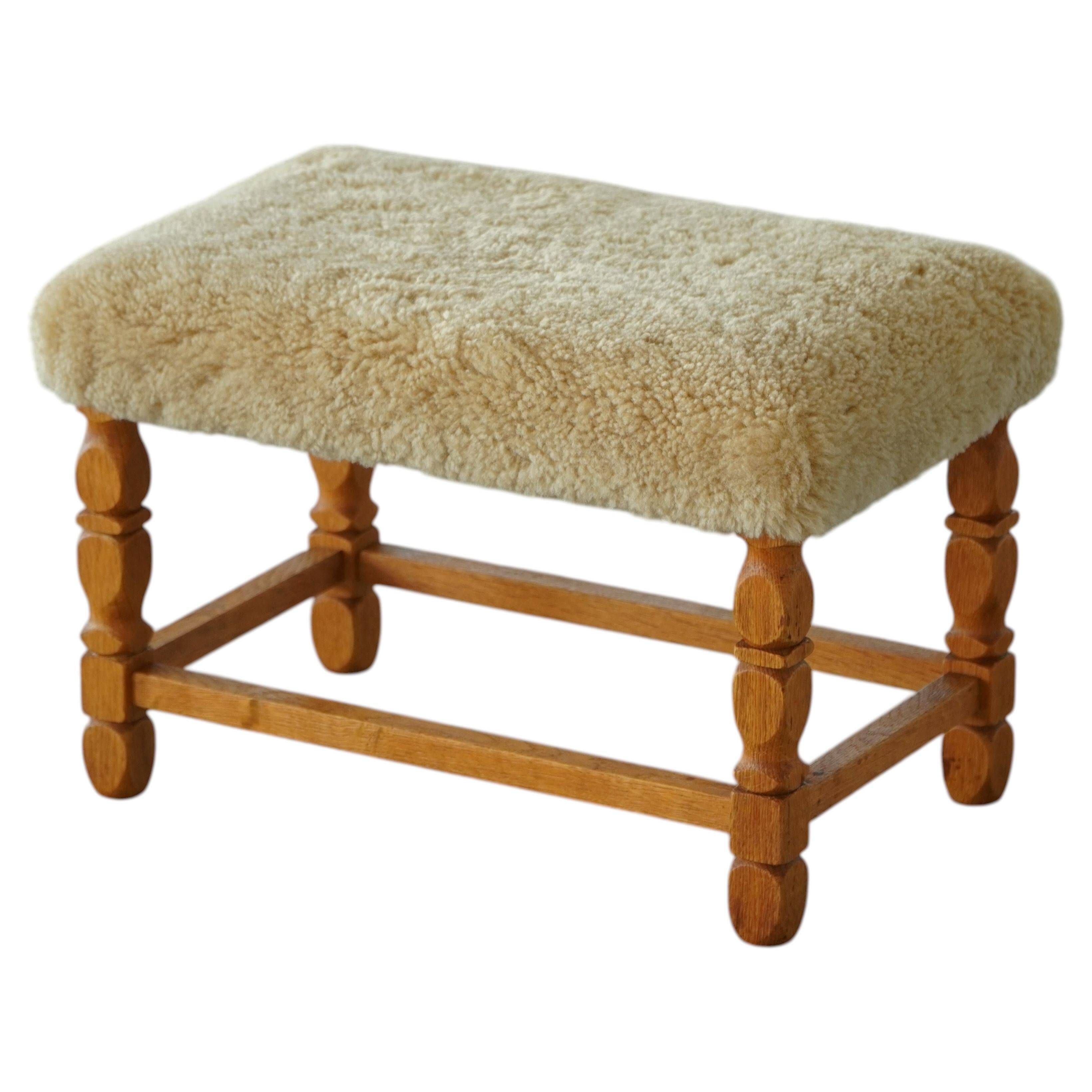Rectangular oak stool, reupholstered in lambswool, Danish cabinetmaker, 1960.