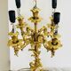 Massive gilded bronze chandeliers from the mid-20th century with marble bases.