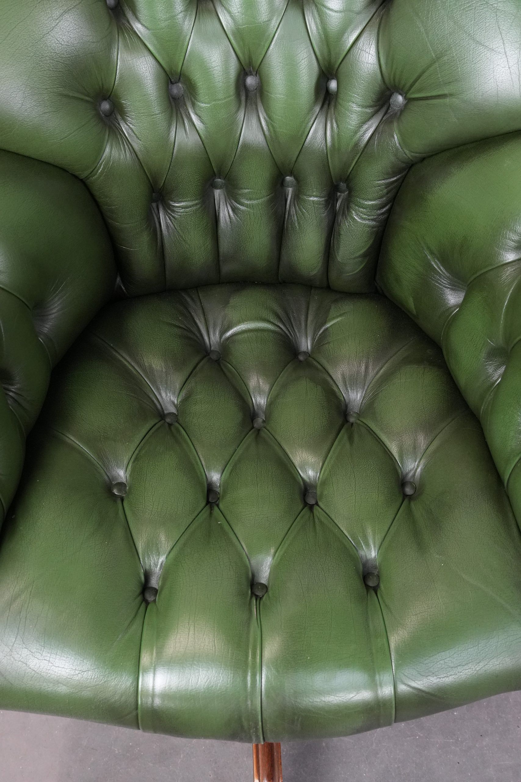 Large green cowhide Chesterfield office chair in English style on wheels