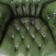 Large Chesterfield office armchair in green cowhide, in English style, on wheels.