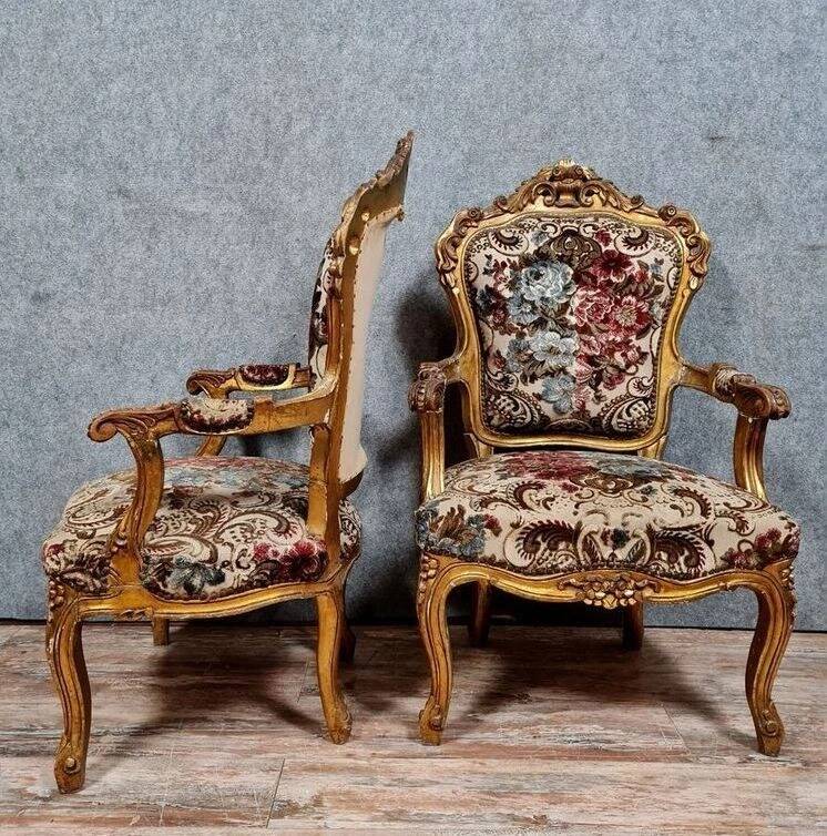 Pair of carved and gilded cabriolet armchairs in the Louis XV style.
