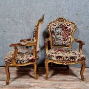 Pair of carved and gilded cabriolet armchairs in the Louis XV style.