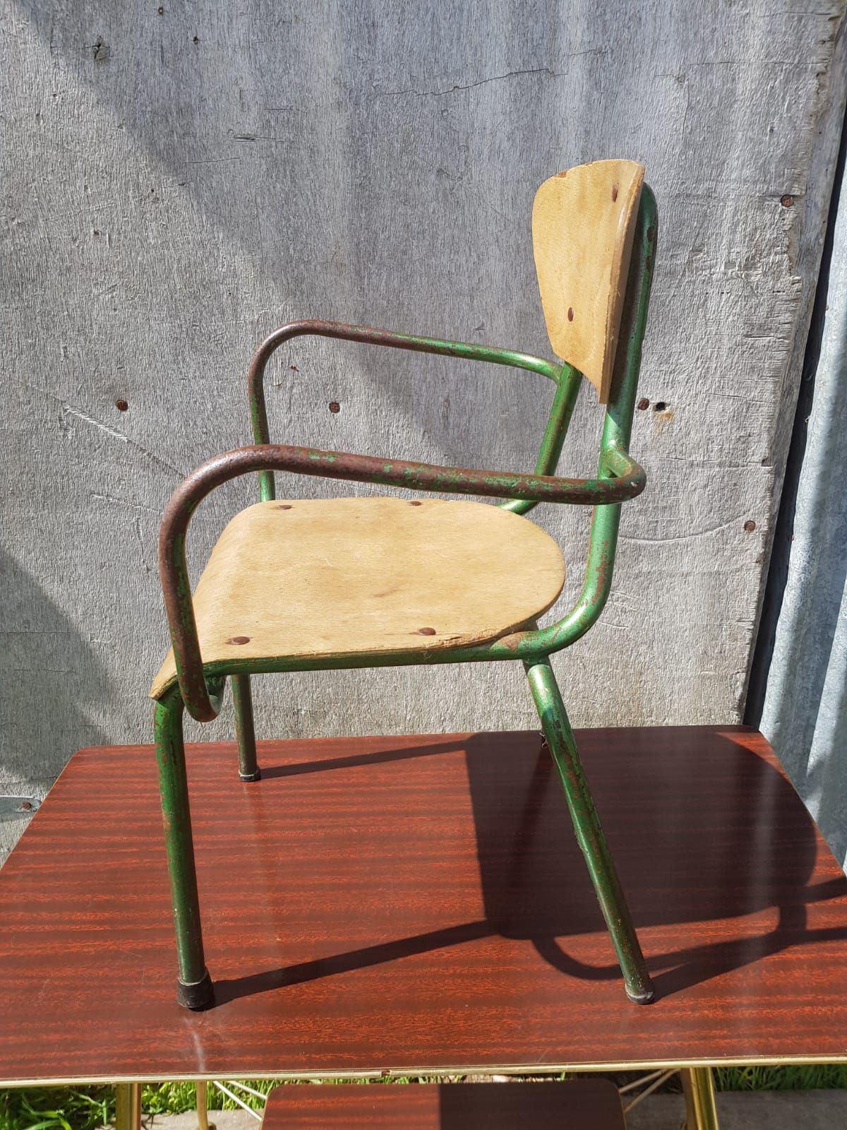 Former green metal child chair