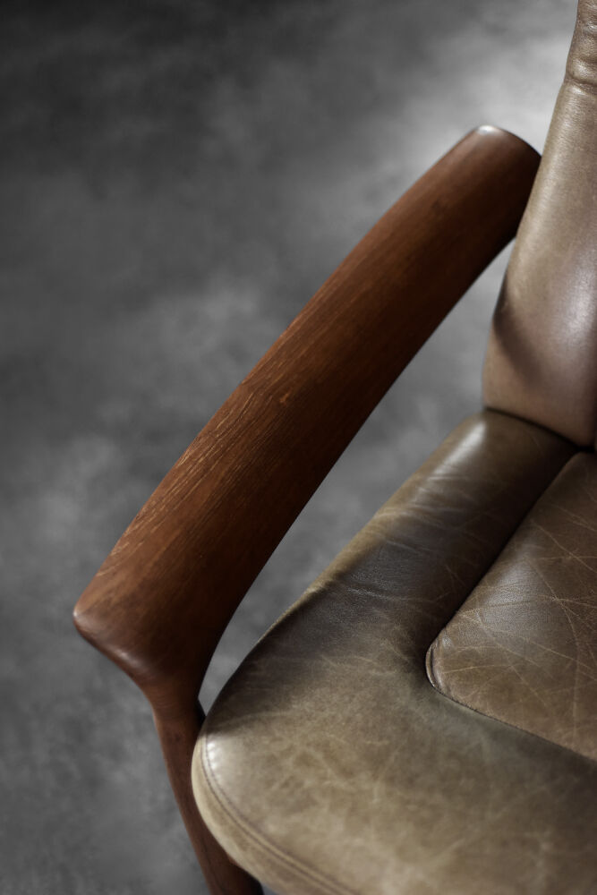 High teak and brown leather armchair with reclining backrest, mid-century Danish style, 1960s.