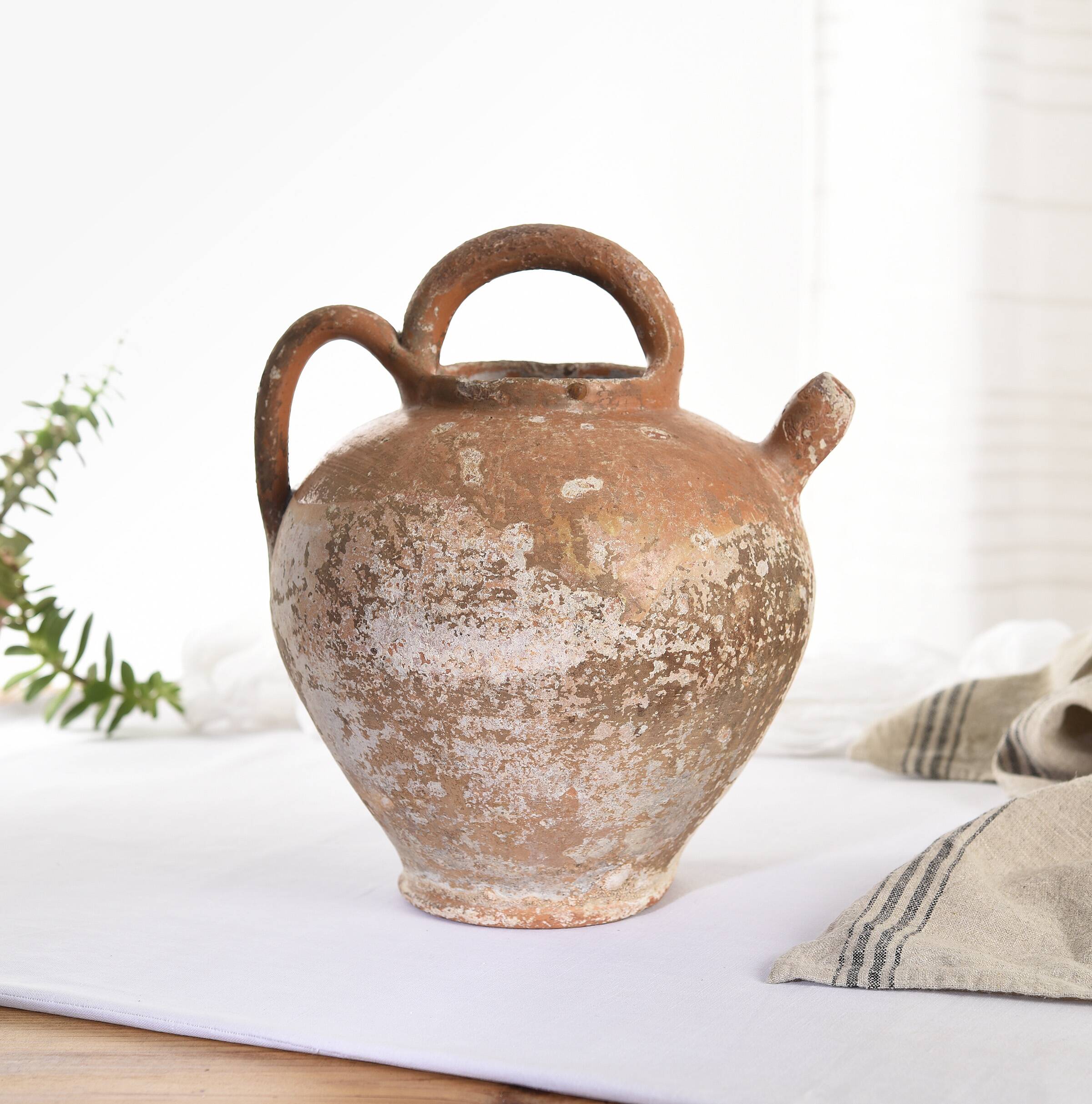 Old water jug. Gargoulette. Old terracotta pitcher.