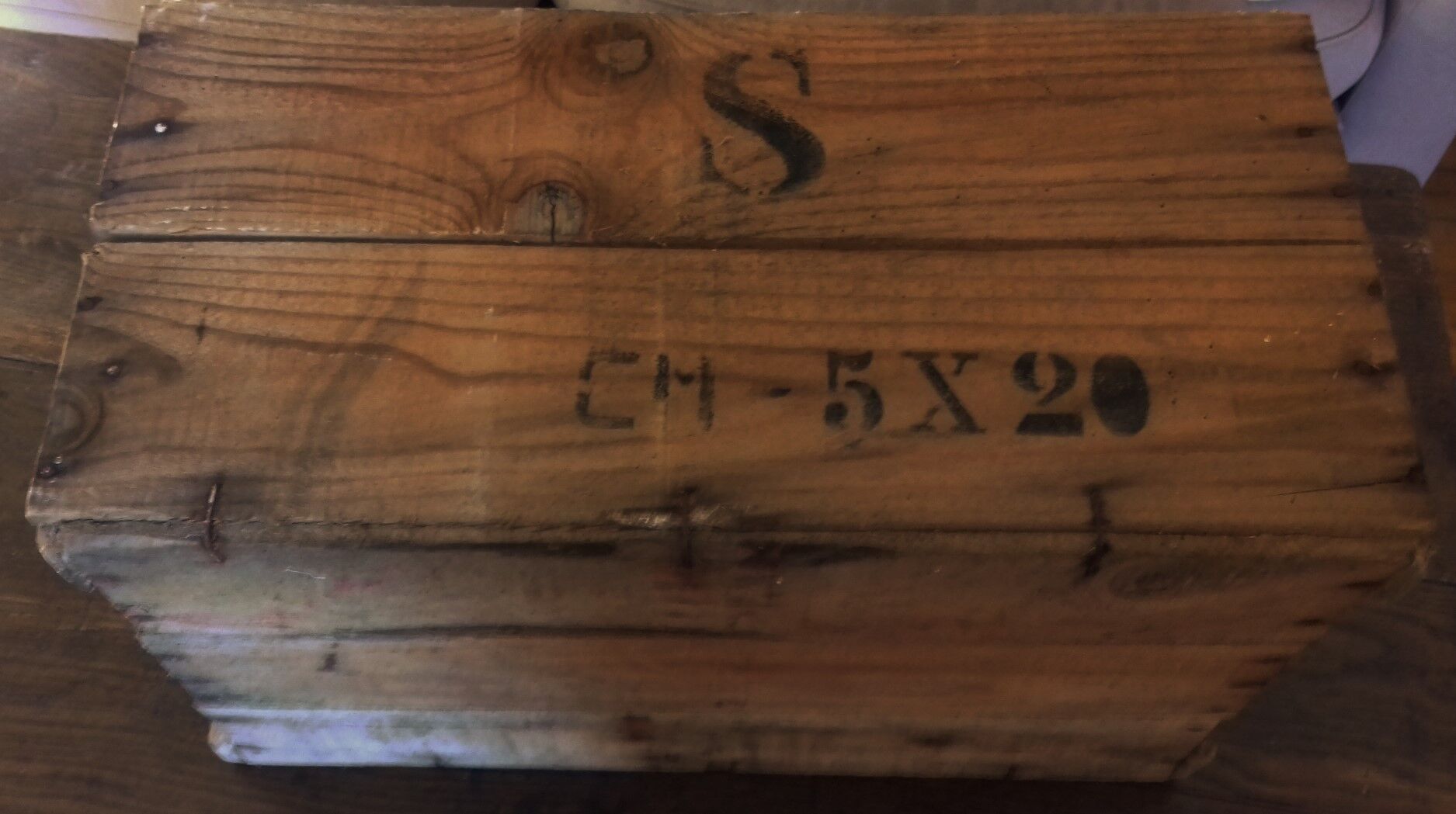 Wooden case with letters in black inck