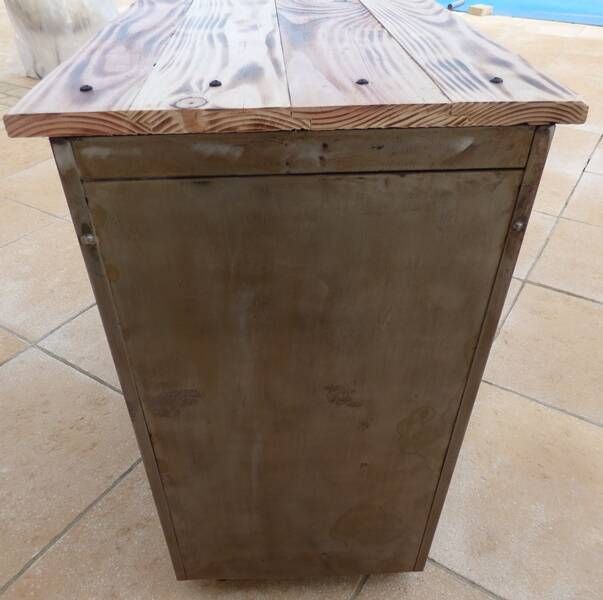 Vintage industrial metal furniture with a rusty effect, featuring two drawers on wheels.