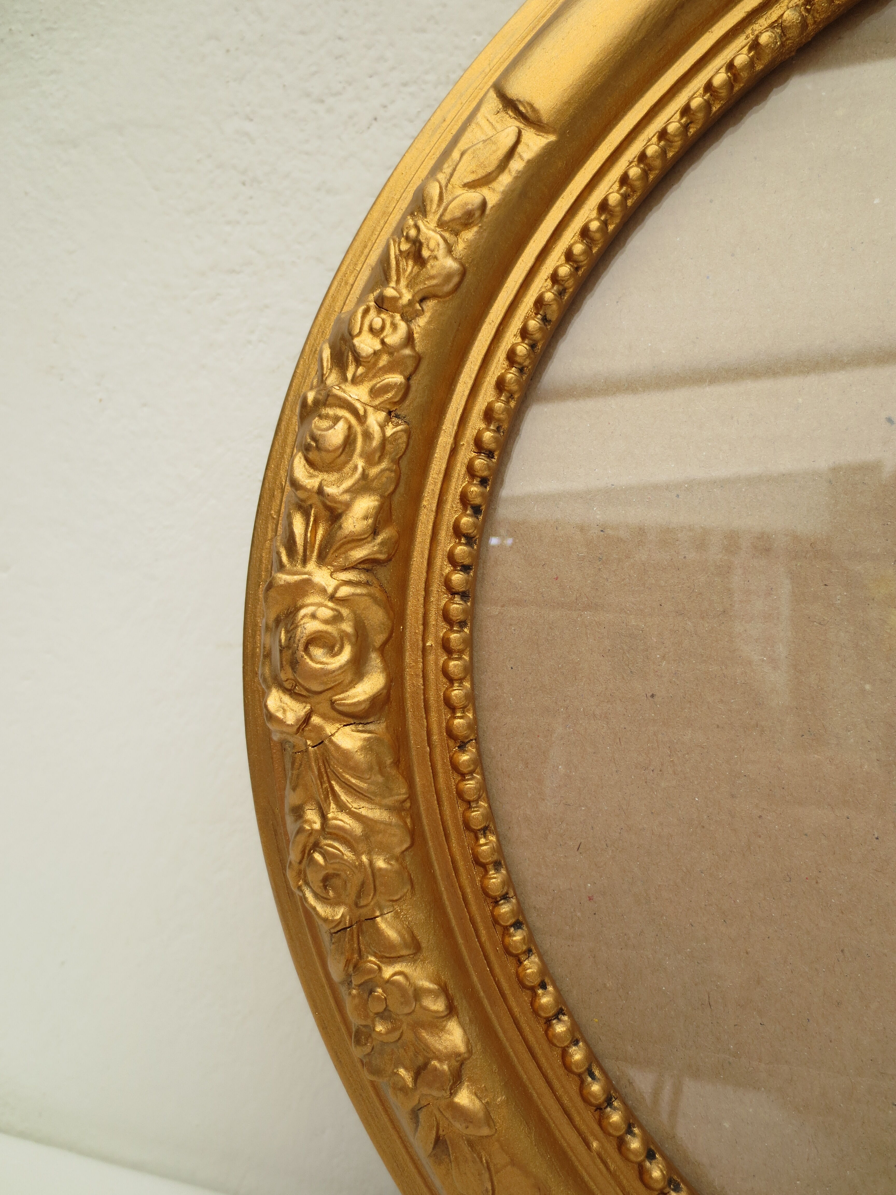 Large old oval gilded wooden frame and stucco decorations