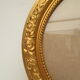 Large old oval gilded wooden frame and stucco decorations