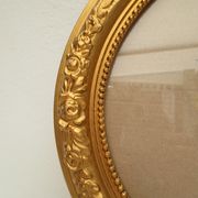 Large old oval gilded wooden frame and stucco decorations