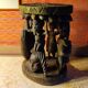 African wooden stool carved in the shapes of characters